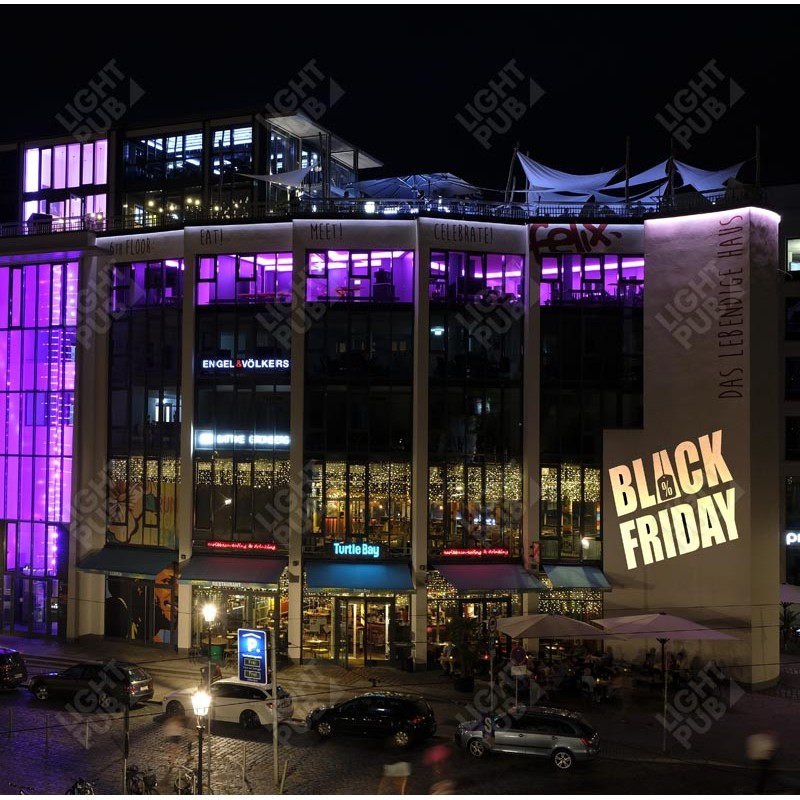 Projection lumineuse publicité black friday sur façade centre commercial boutique magasin